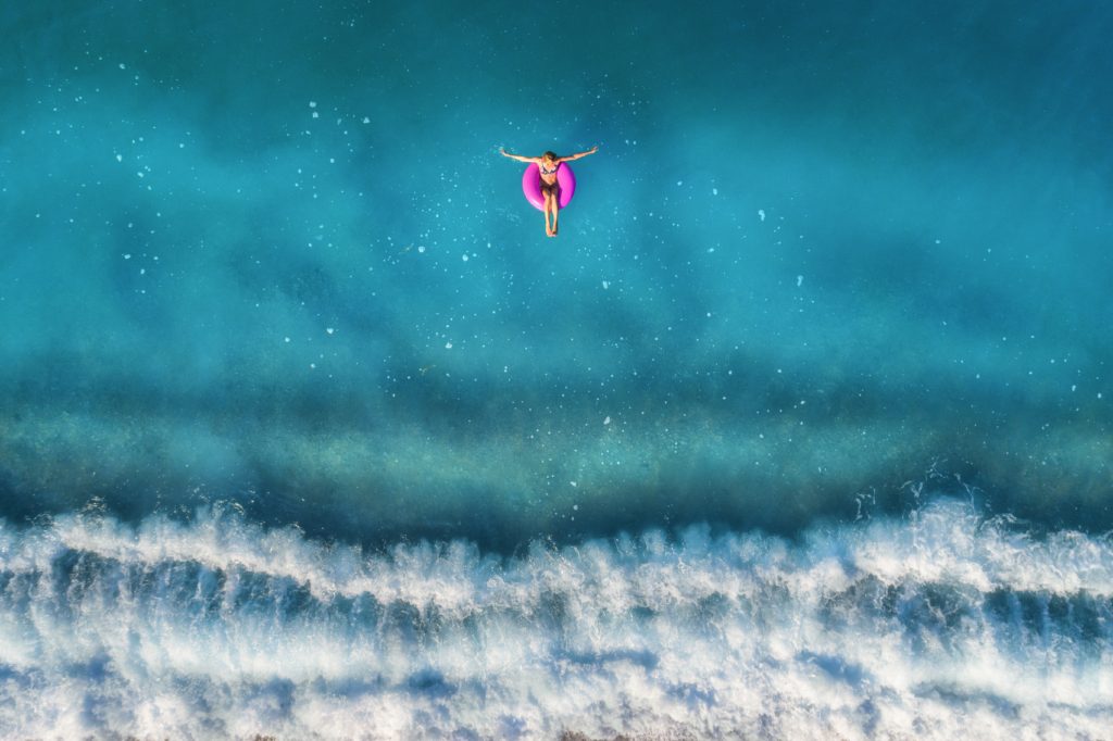 Girl floating in the blue lagoon